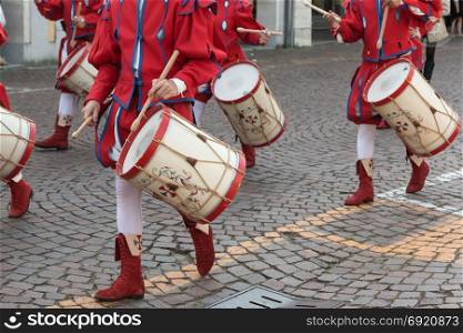 Drummers in Red and White Uniform Playing Snare Drums in Parade