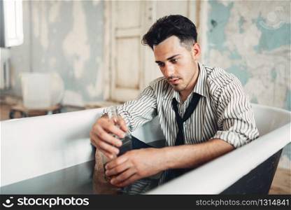 Drunk businessman in bathtub, suicide man concept. Problem in business, stress. Drunk businessman in bathtub, suicide man concept