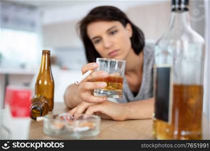 drunk woman holding an alcoholic drink