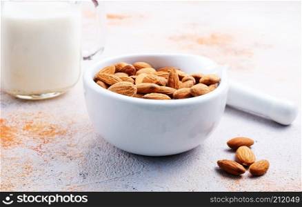 dry almond in bowl, superfood, almond and milk on a table