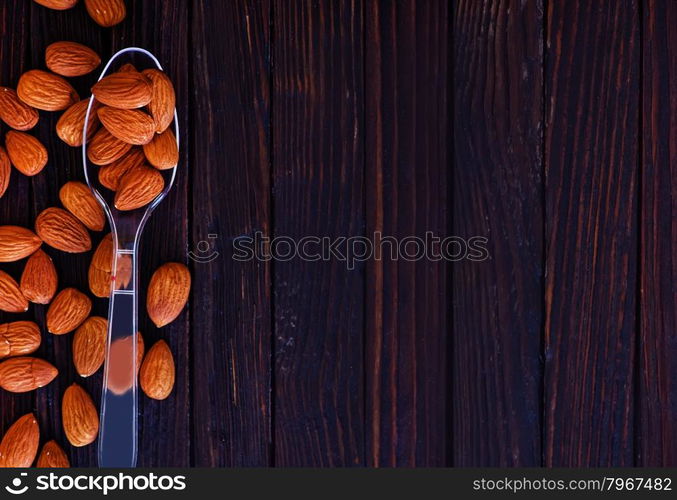 dry almond in spoon and on a table