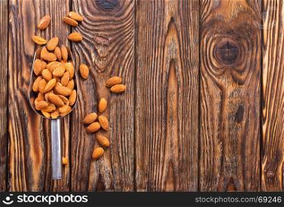 dry almond on the wooden table, stock photo