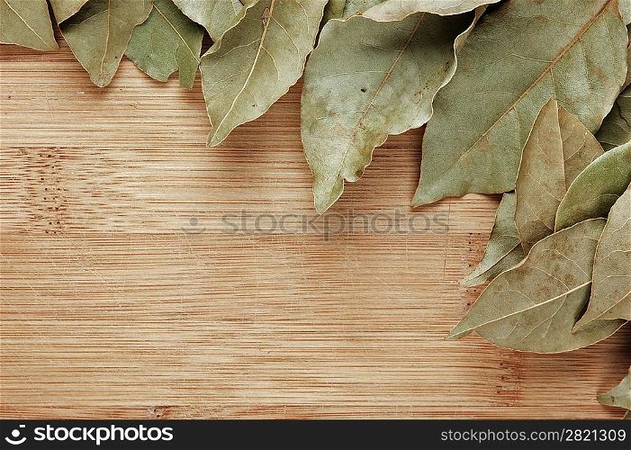 dry bay leaf on a wooden kitchen board