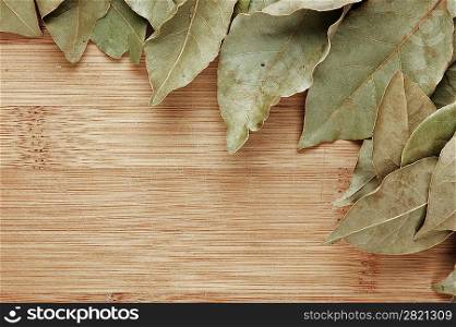 dry bay leaf on a wooden kitchen board
