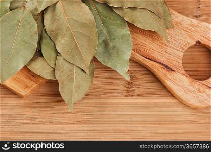 dry bay leaf on a wooden kitchen cutting board