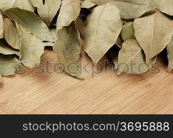 dry bay leaf on a wooden kitchen cutting board