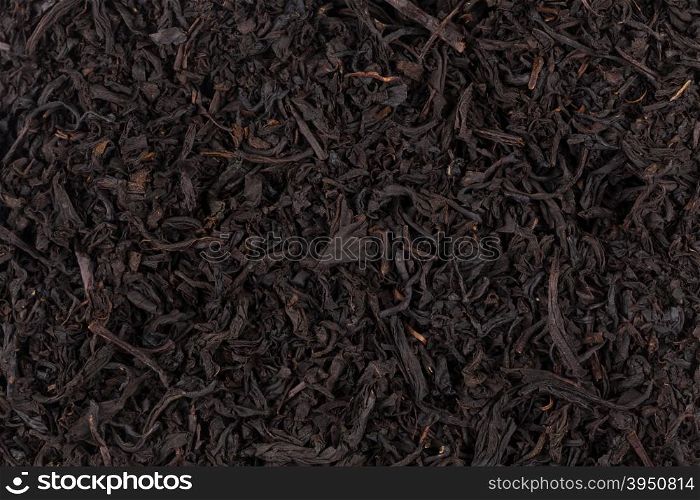 dry black tea leaves close up of texture for background