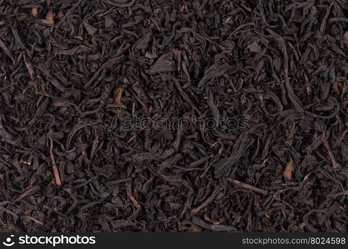 dry black tea leaves close up of texture for background