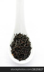 Dry black tea leaves in a spoon