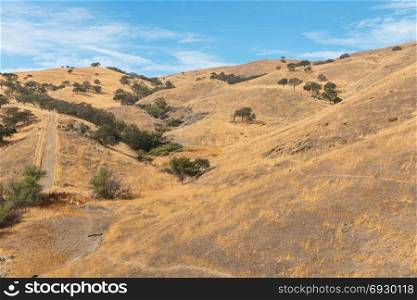 Dry brown hills along Pacheco Pass near Los Banos, California