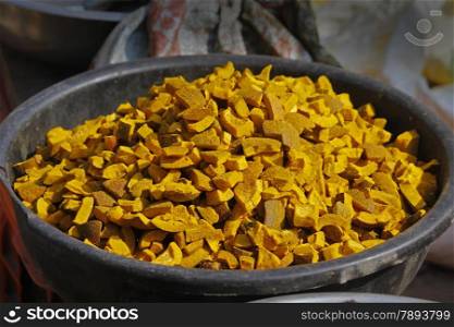 Dry coconut pieces with Turmeric, Curcuma longa for sell at marketplace