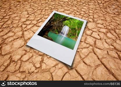 Dry cracked earth background and waterfall picture