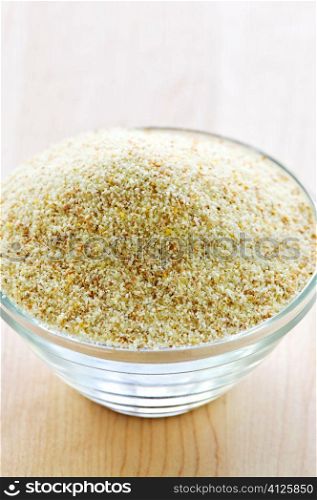 Dry cream of wheat cereal in a glass bowl