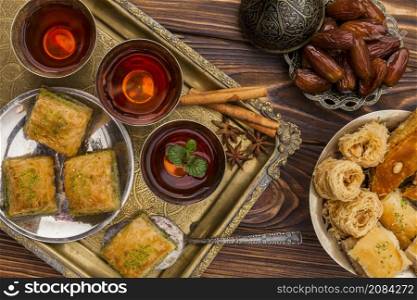 dry dates saucer near cups tea turkish desserts tray