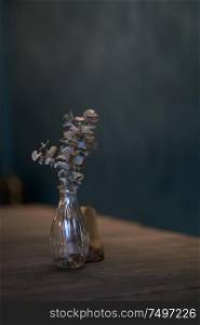 Dry flower and on wooden table for decoration with blur wall background