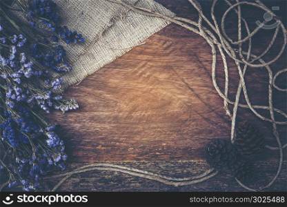 Dry flower frame on wood background with vintage filter effect