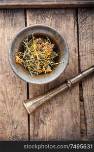 Dry hypericum on wooden table.Medicinal herbs and alternative medicine. Hypericum healing plant