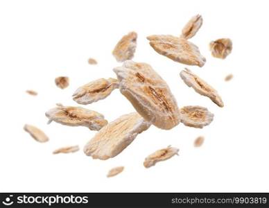 Dry oat flakes levitate on a white background.. Dry oat flakes levitate on a white background