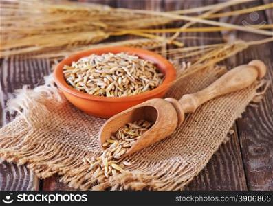 dry oat in bowl and on a table
