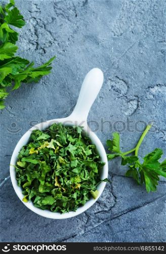 dry parsley in bowl and on a table
