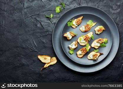 Dry pear,blue cheese and walnut appetizer.Space for text. Blue cheese with dried pears and walnuts