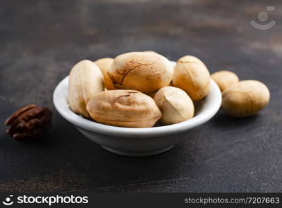 dry pecan in white bowl on a table