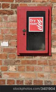 dry riser fire extinguisher inlet (brick wall background)