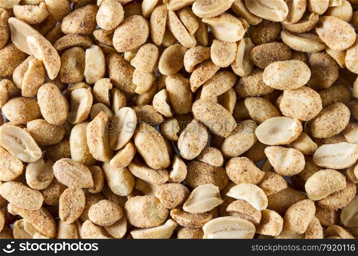 Dry roast peanuts, close up so they form a background or macro.