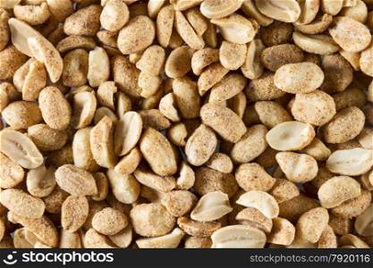 Dry roast peanuts, close up so they form a background or macro.