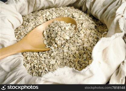 Dry rolled oats seed and wooden spoon