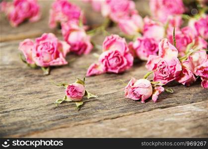 dry roses on a wooden background