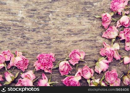 dry roses on a wooden background