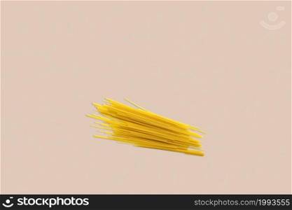 Dry spaghetti on a red background for the menu. Geometric background. Flat lay, copy space, top view.