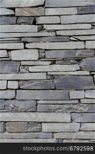Dry stone slate wall making background texture