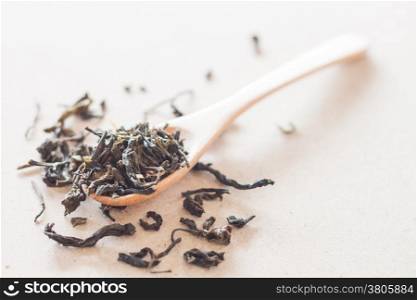 Dry tea in wooden spoon, stock photo