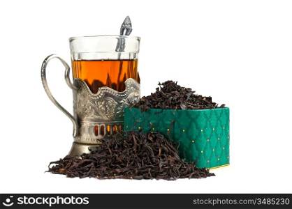 dry tea leaves in a box and glass isolated on white