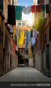 Drying clothes on venetian street at sunny day, Italy
