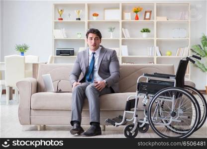 Dsabled businessman on wheelchair working home. Disabled businessman on wheelchair working home