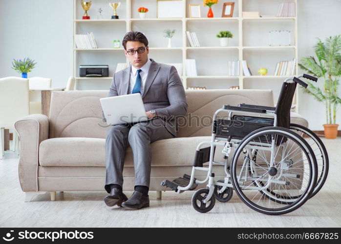 Dsabled businessman on wheelchair working home. Disabled businessman on wheelchair working home