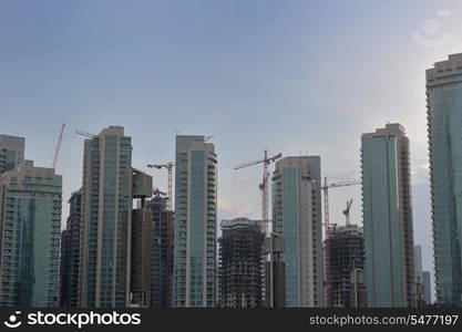 dubai city skyline at sunset conctruction and modern architecture concept