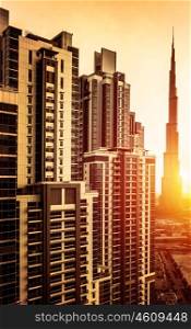 Dubai downtown in sunset, UAE, beautiful tall buildings in bright yellow sul light, burj khalifa, business centre, luxury travel and tourism concept