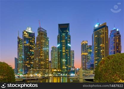 Dubai Marina and harbour at sunset - Illuminated modern towers in the evening, United Arab Emirates