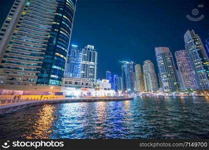 Dubai Marina night skyline. Buildings and river, United Arab Emirates.