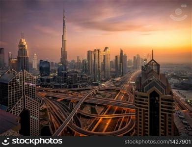 Dubai Skyline from hotel at blue hour sunset. Skycrapers can be seen as Burj Khalifa and Sheikh Zayed Road.