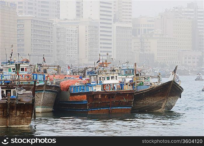 Dubai, UAE, Dhows, old wooden sailing vessels, are docked along the Deira side of Dubai Creek.