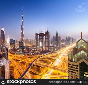 DUBAI, UAE - FEBRUARY 16: Burj Khalifa the tallest building in the world. Dubai Downtown cityscape. Dubai evening skyline, busy Sheikh Zayed road intersection, sunset on February 16, 2018 in Dubai