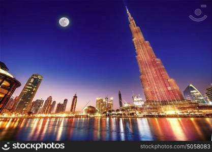 DUBAI, UAE - FEBRUARY 17: Burj Khalifa and fountain - world's tallest tower at 828m at night with moon light, located in Downtown Dubai, Burj Dubai on February 17, 2016 in Dubai, United Arab Emirates