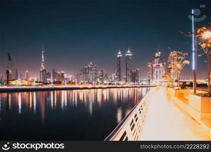 DUBAI, UAE - FEBRUARY 2018  Colorful sunset over Dubai Downtown skyscrapers and the newly built Tolerance bridge as viewed from the Dubai water canal.