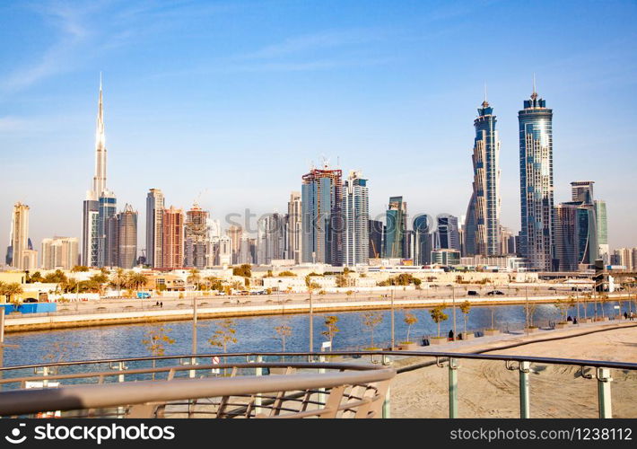 Dubai, UAE - FEBRUARY 2018:Dubai Downtown skyscrapers and Burj Khalifa as viewed from the Dubai water canal