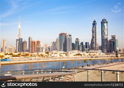Dubai, UAE - FEBRUARY 2018:Dubai Downtown skyscrapers and Burj Khalifa as viewed from the Dubai water canal